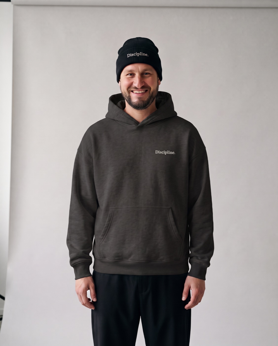 Yves Benini in the studio in the black Oversized Hoodie and black Rib Beanie